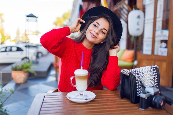 Young woman enjoying an outdoor coffee shop